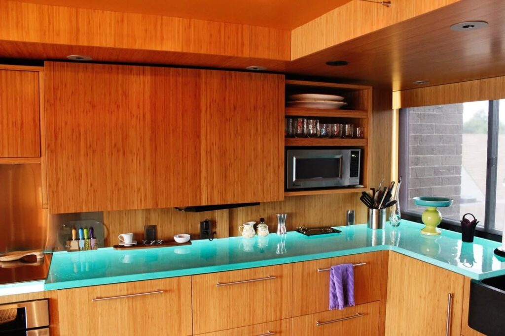 Bamboo Cabinetry with Aqua Glass and Orange Undertones