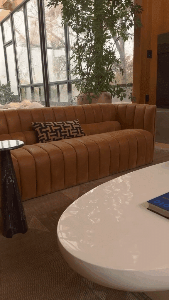Camel Channel Tufted Sofa in a Glass Room