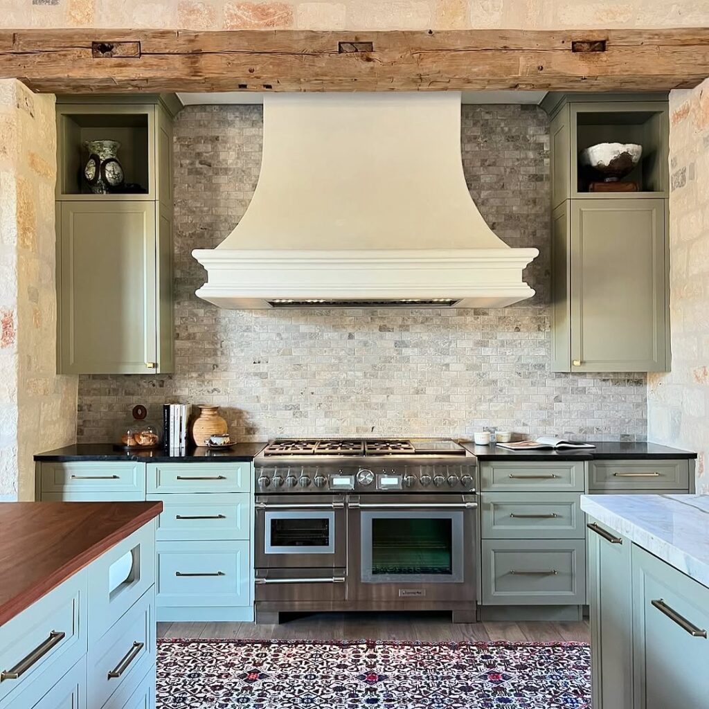 Subdued Sage Green Cabinetry and Rustic Beam