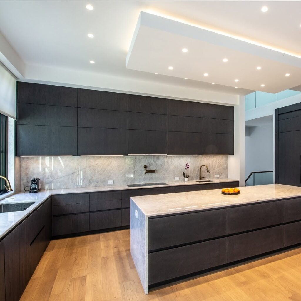 Dark cabinetry and waterfall quartz