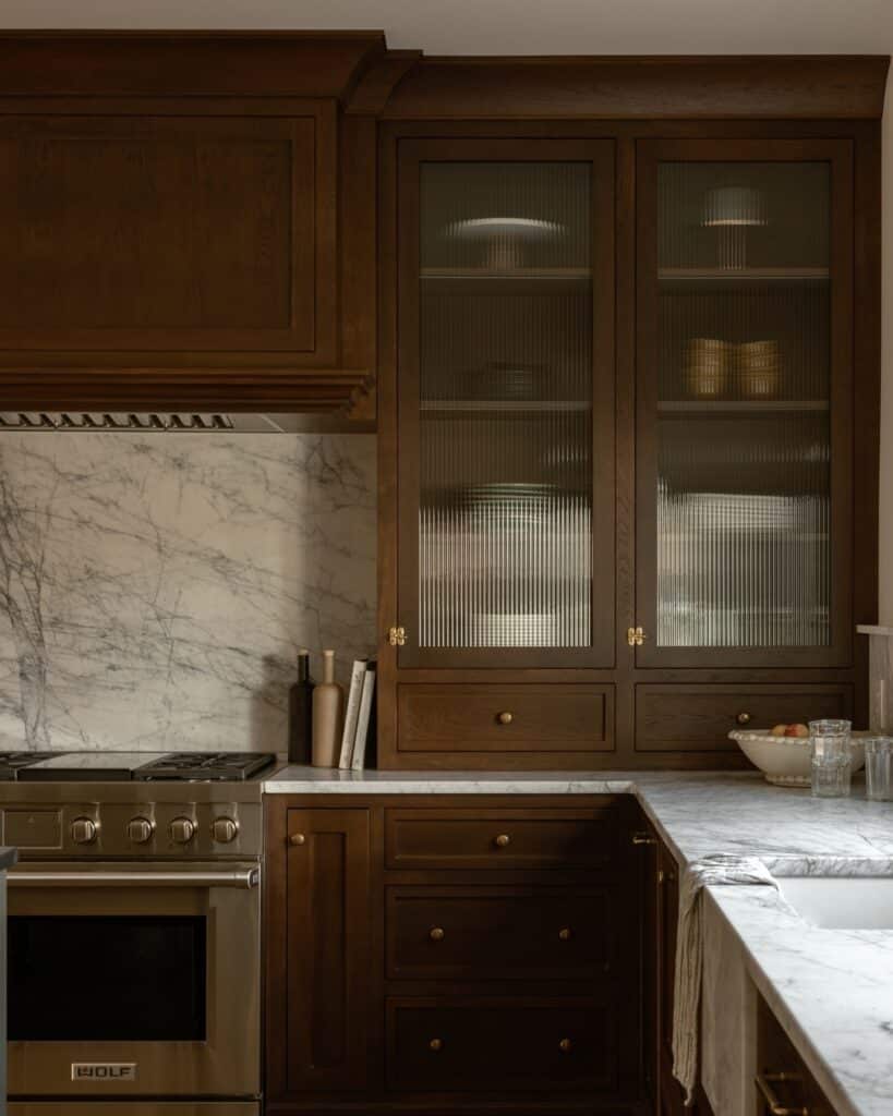 European Walnut Cabinetry with Brass and Fluted Glass