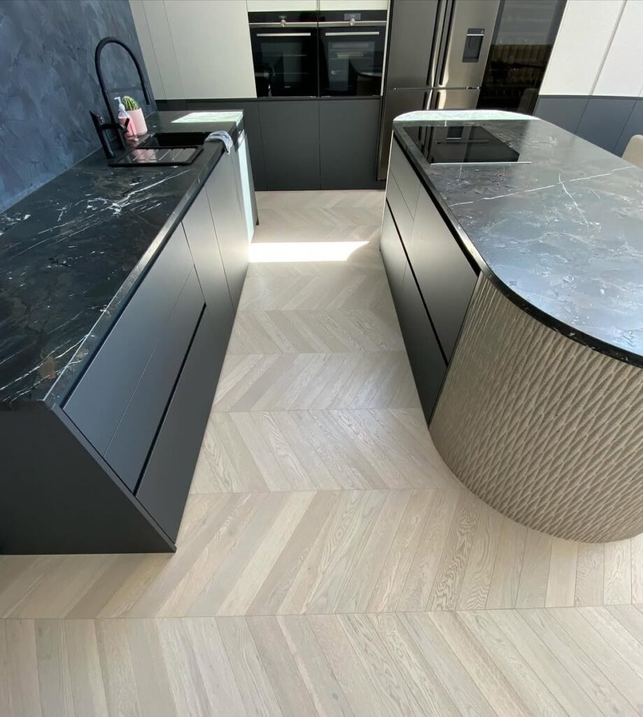 Herringbone Wood Flooring with Dark Grey Cabinetry