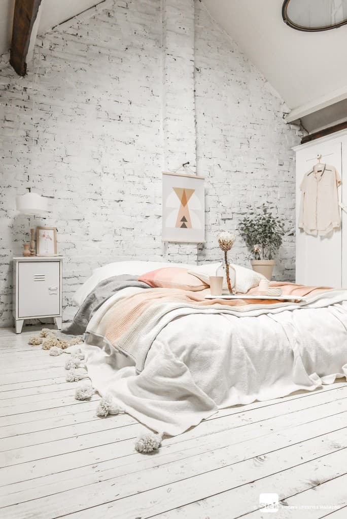 attic bedroom with white washed wall