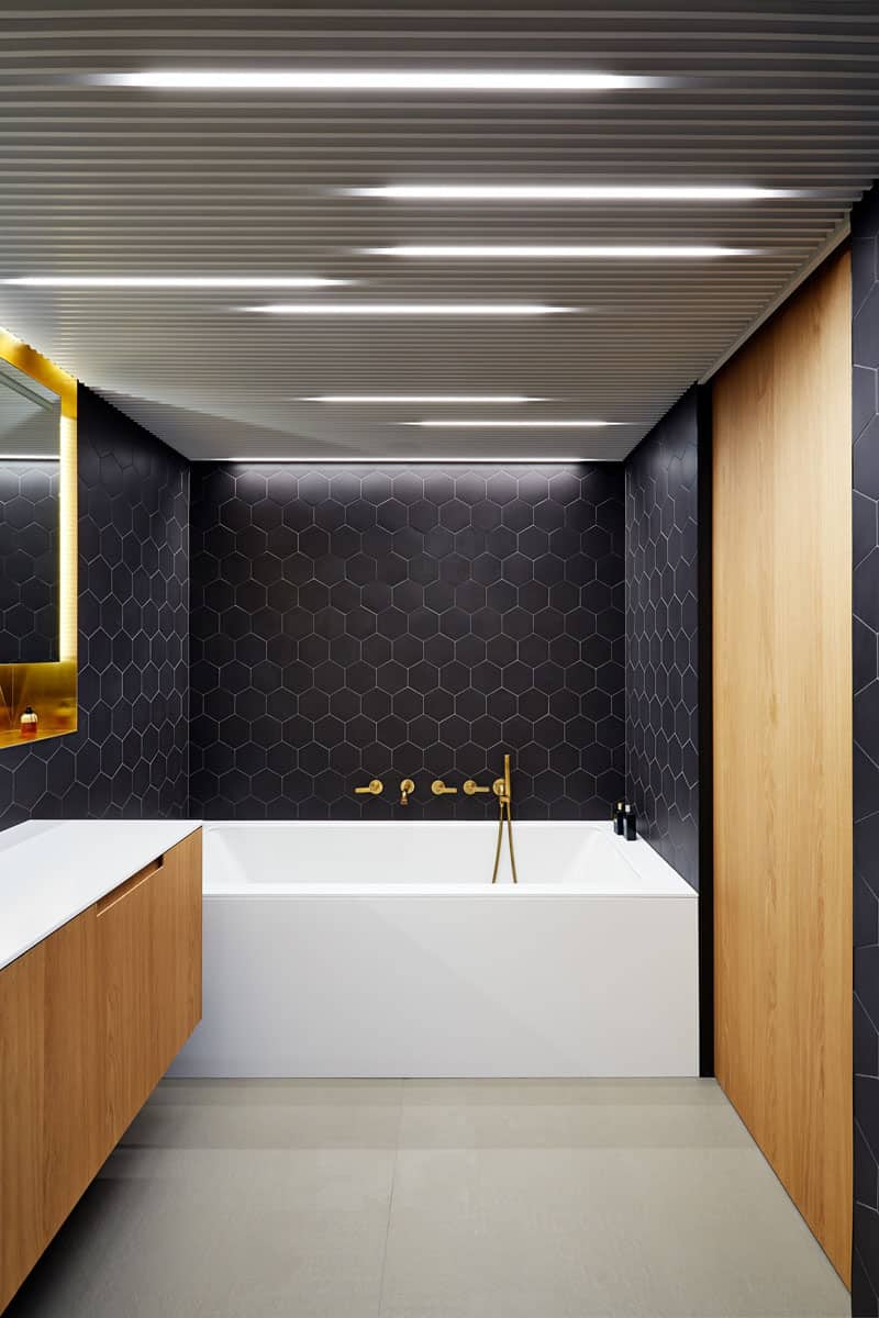 Black, brass, and wood bath