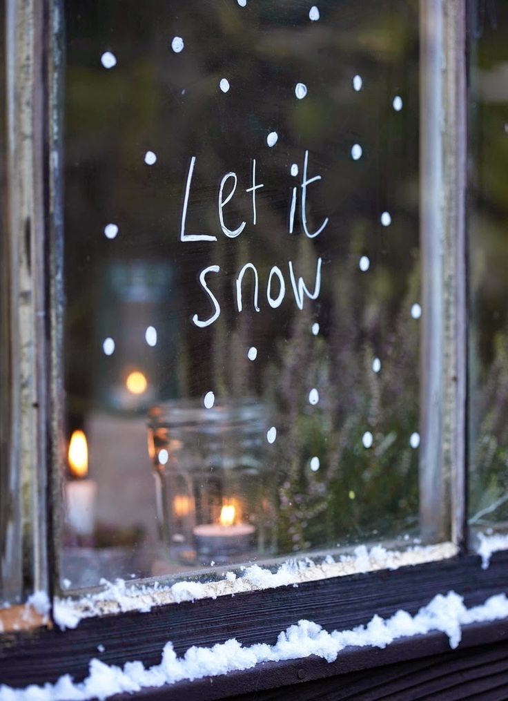 'Let It Snow' written on window in temporary white window marker.