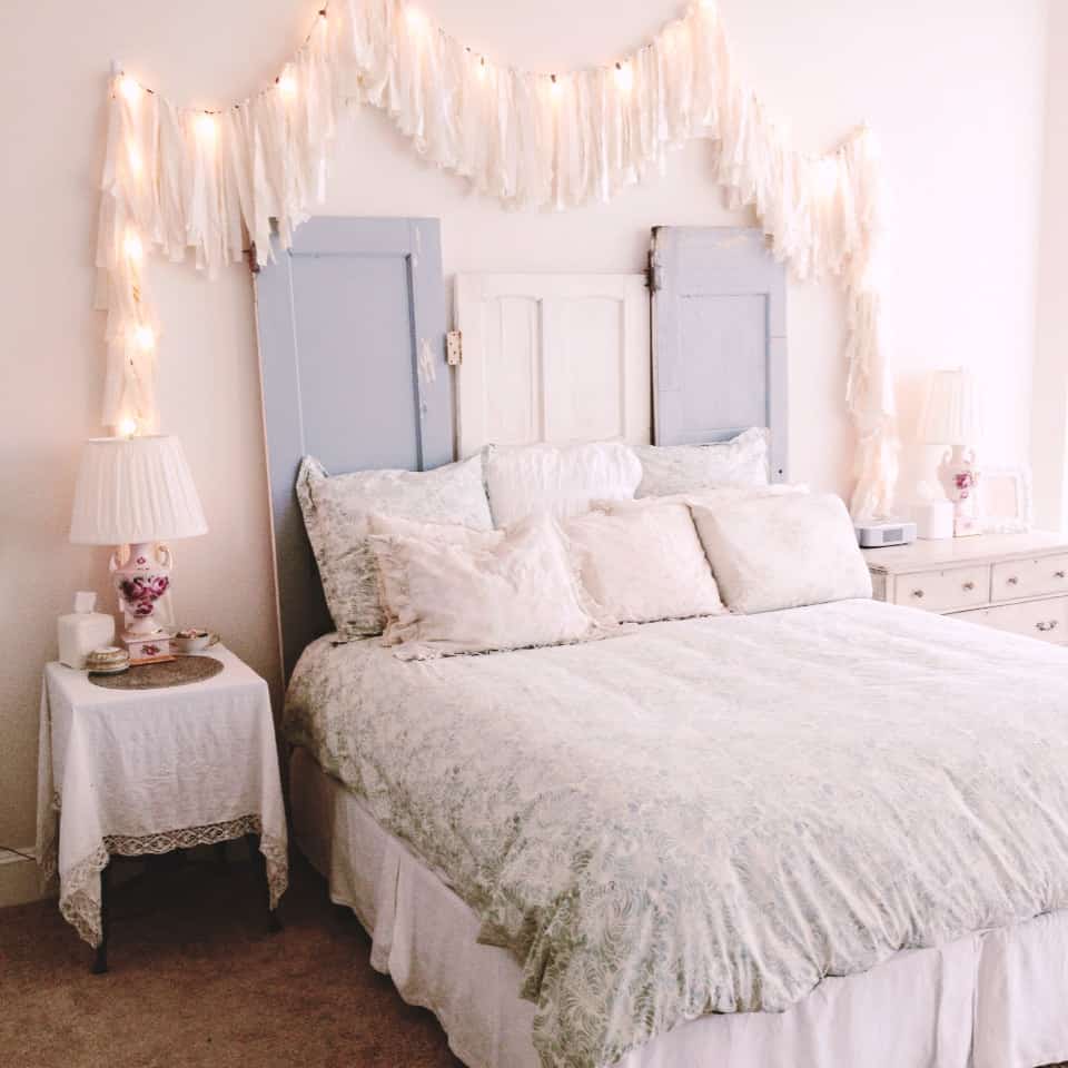 Using Christmas lights as part of your headboard decor creates a shabby chic decor space that is simple and intriguing all at once.