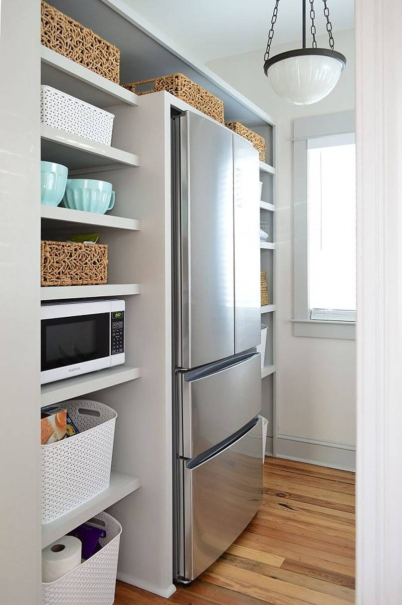 Refrigerator surrounded by shelves