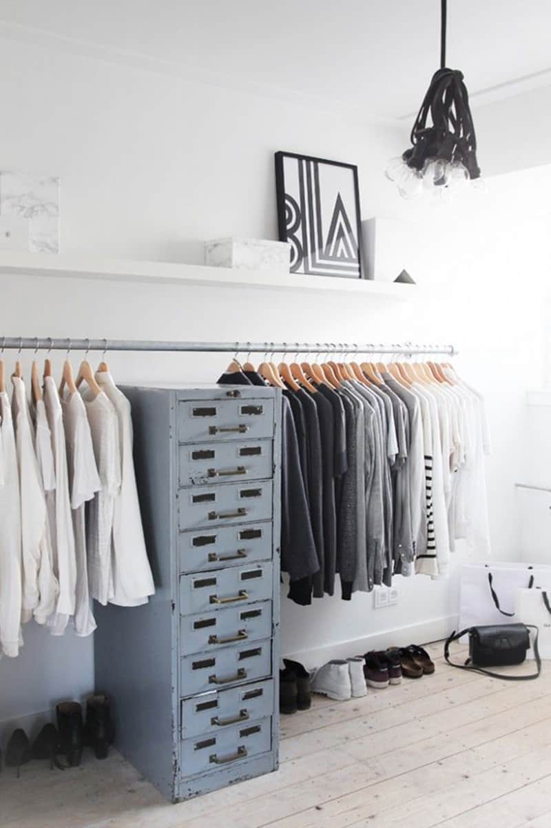 Repurposed metallic cabinet complements a continuous clothing rack