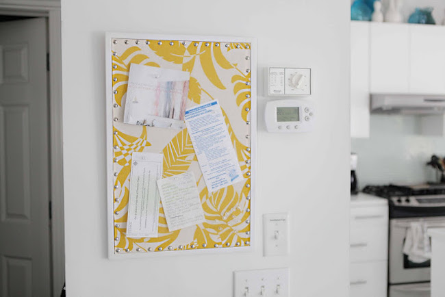 Tropical white and yellow fabric covering a cork board