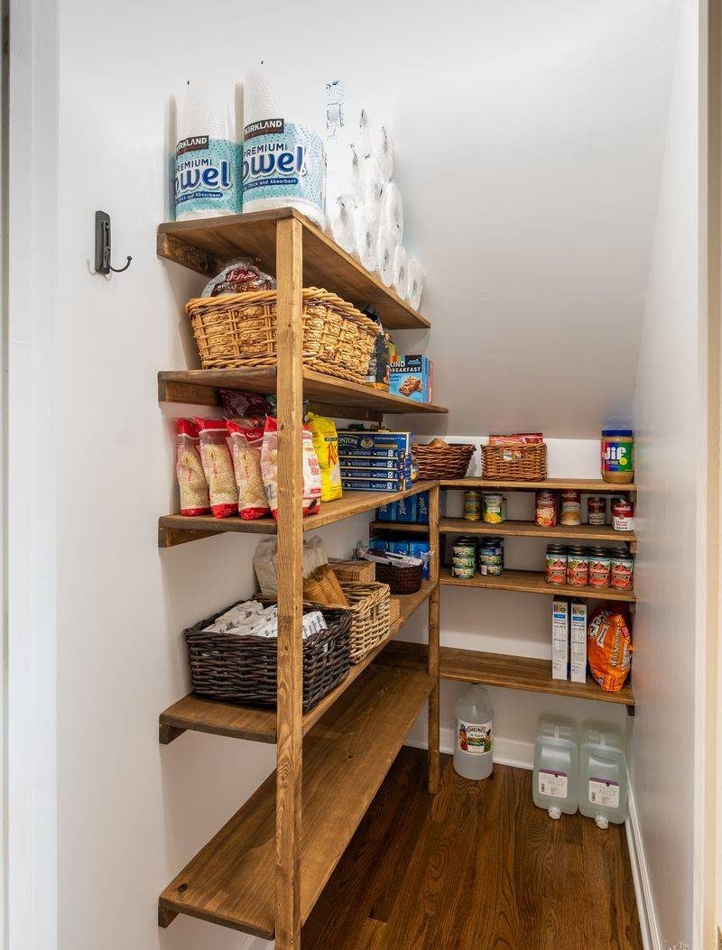 Walk-in pantry with wooden shelves