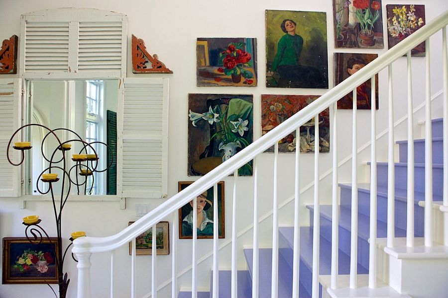 Wall art adds to the shabby chic style of the staircase in white [Design: Alison Kandler Interior Design]