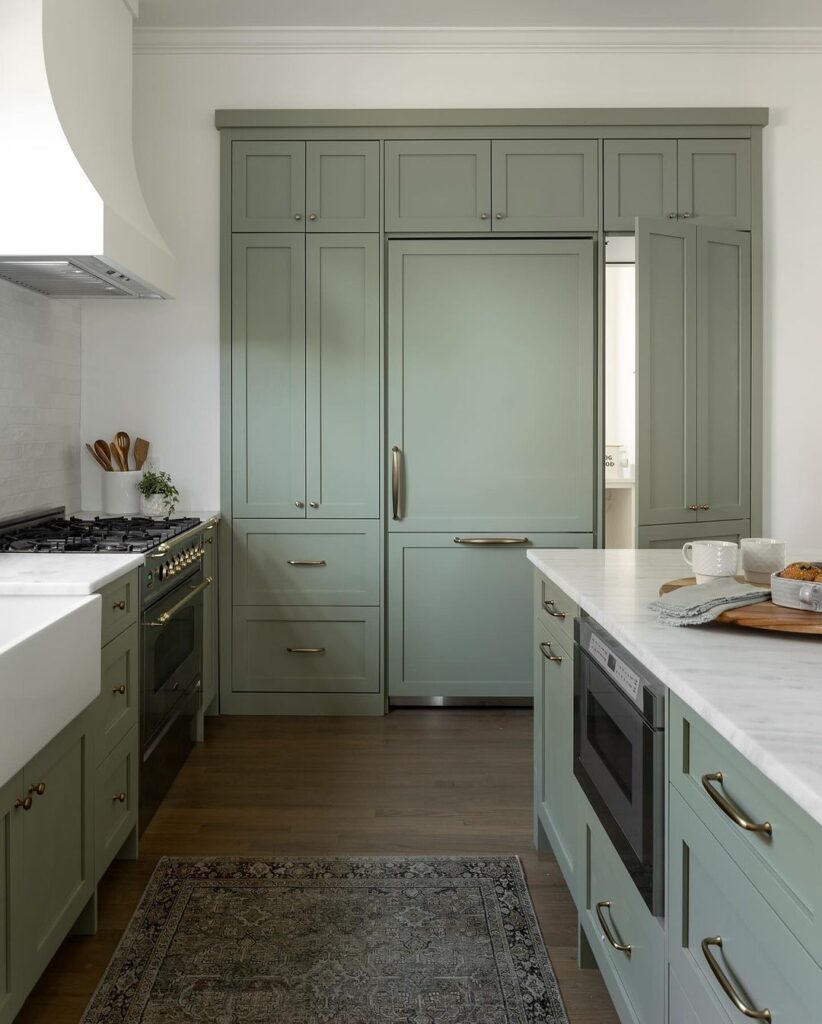 Classic sage cabinetry with a concealed pantry entrance