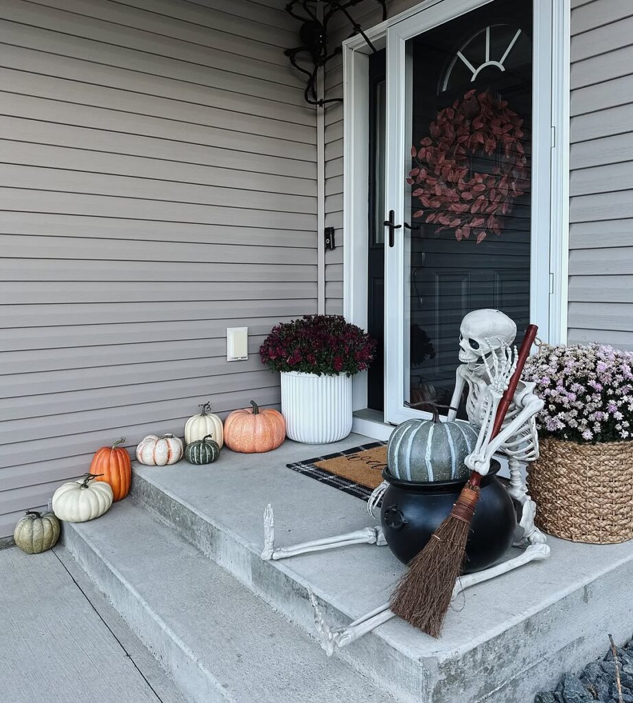 Skeleton Porch with Cauldron and Pumpkins