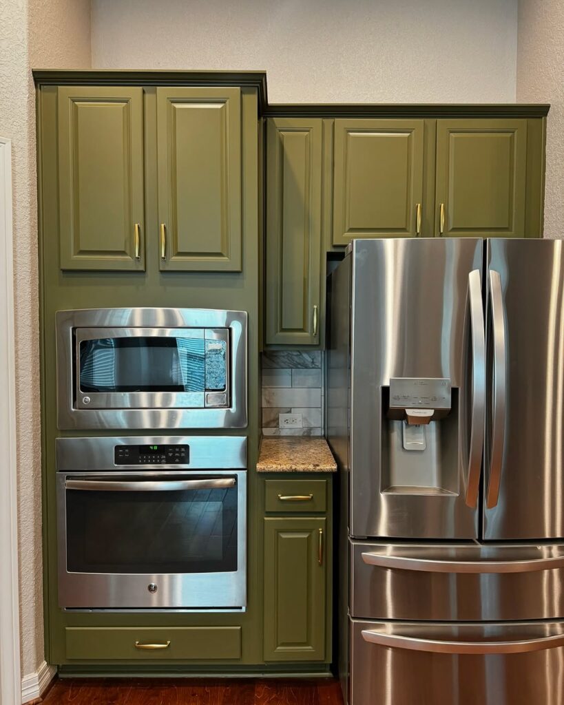 Compact Kitchen with Olive Cabinetry and Stainless Steel Accents
