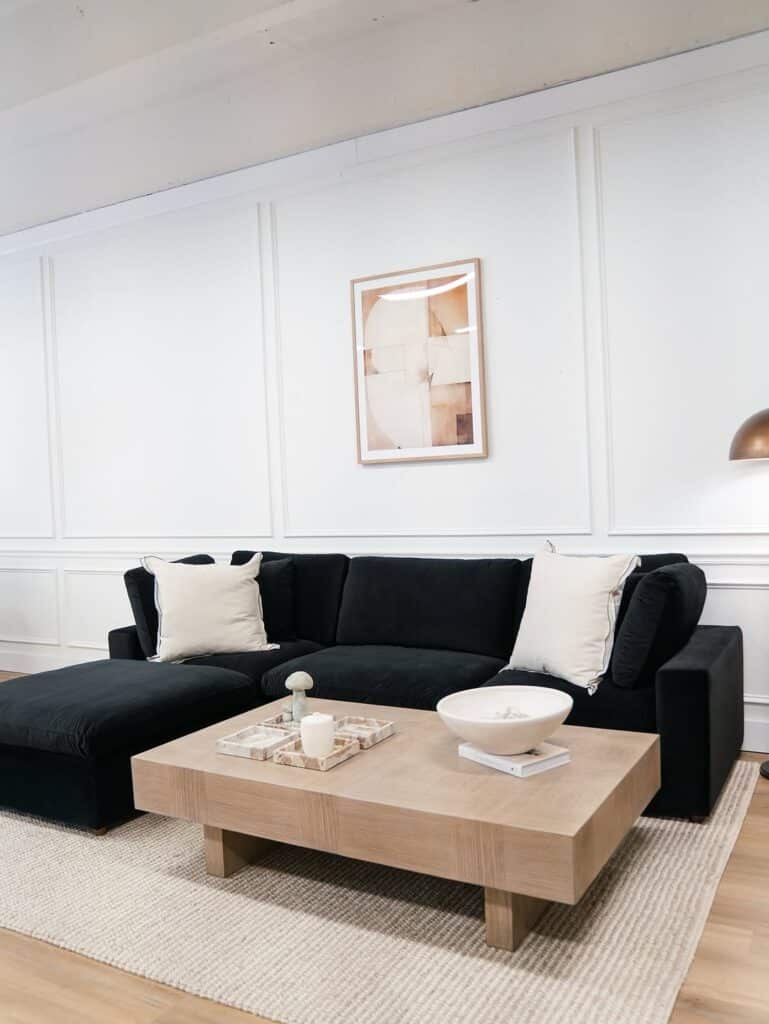 Bright Minimalist Living Room Anchored by Black Sectional