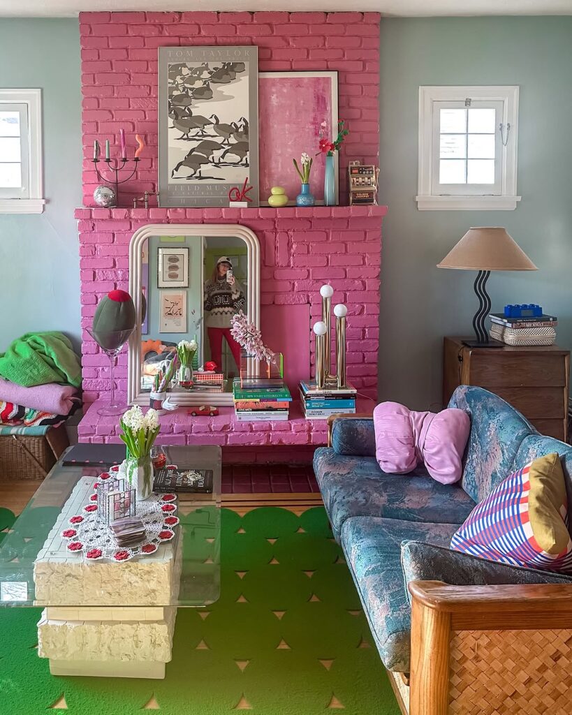 Bright Pink Fireplace Green Accent Chairs Patterned Throws and Botanical Décor