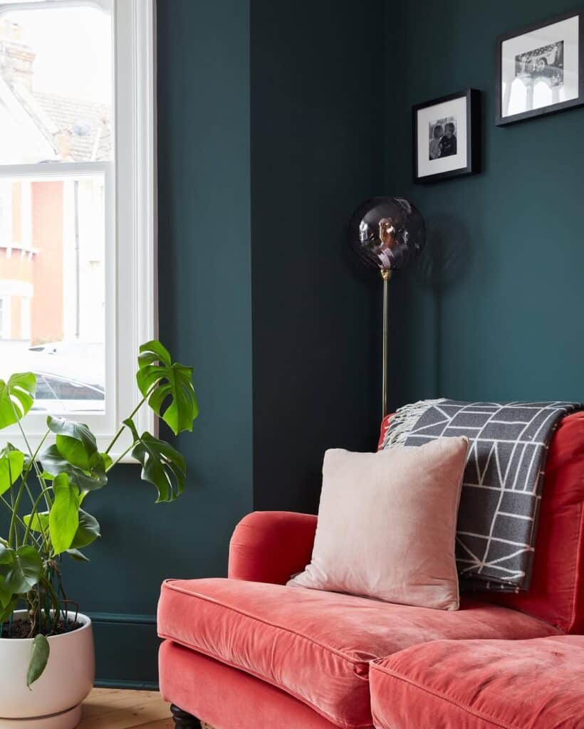 Coral velvet seats surrounded by deep green walls