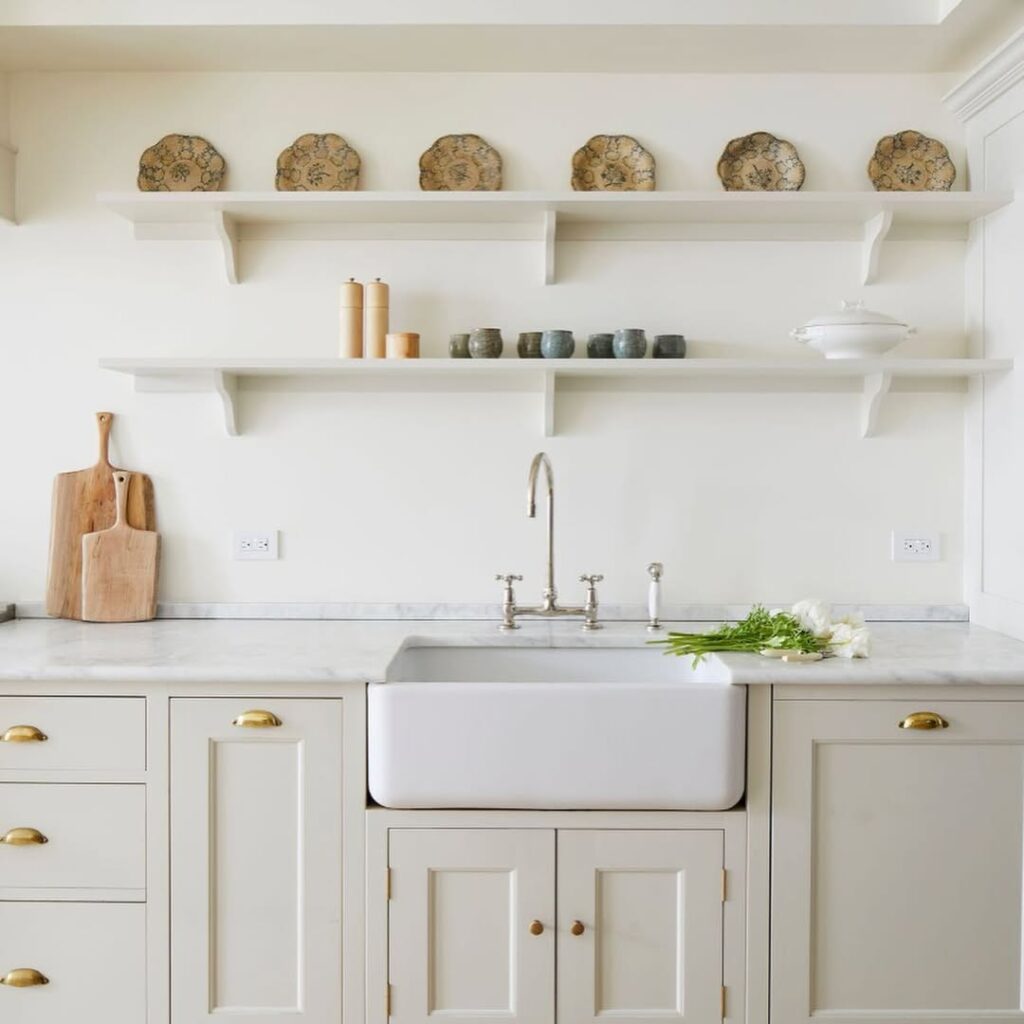 Cream Cabinets With a Farmhouse Marble Sink