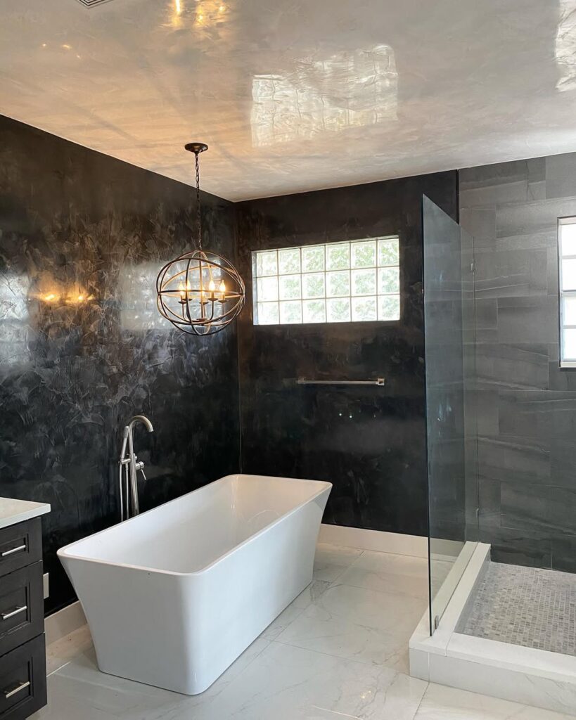 Freestanding Bathtub Against a Textured Black Wall