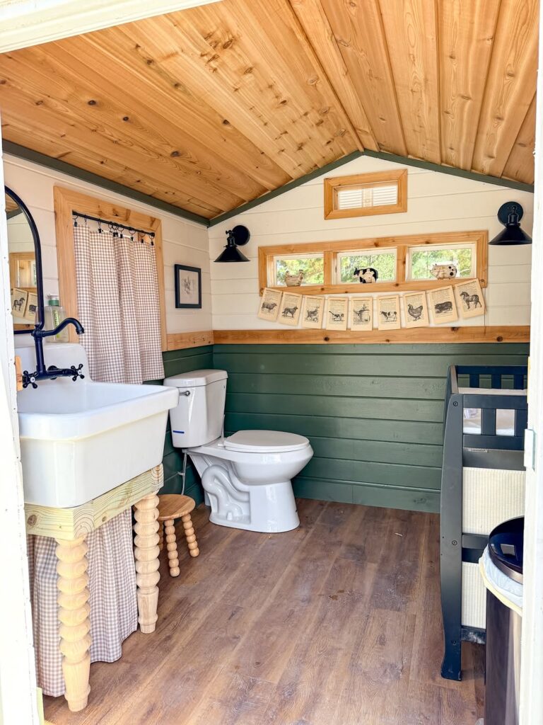 Green Farmhouse Cottage Sink Nook with Painted Cabinetry and Wall Paneling