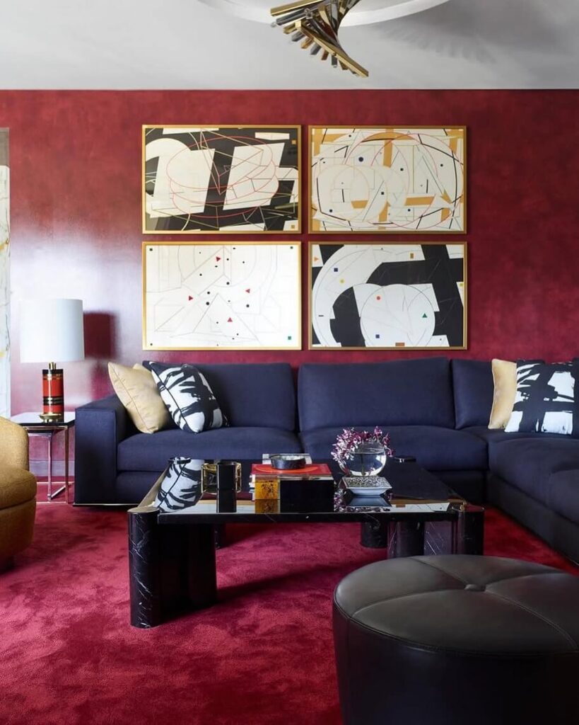 Modern art in the gallery setting of a burgundy high-contrast lounge