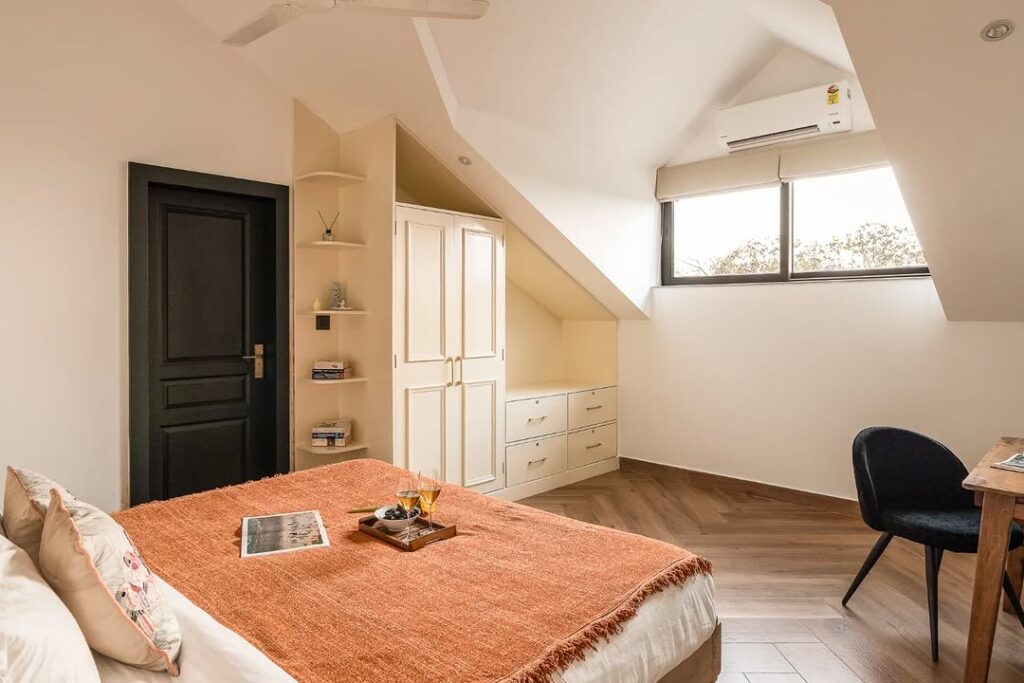 Modern Warm Sloped Ceiling Bedroom with Built-In Features