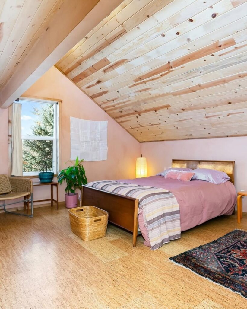 Peach Bedroom Retreat with Pinewood and a Sloped Ceiling