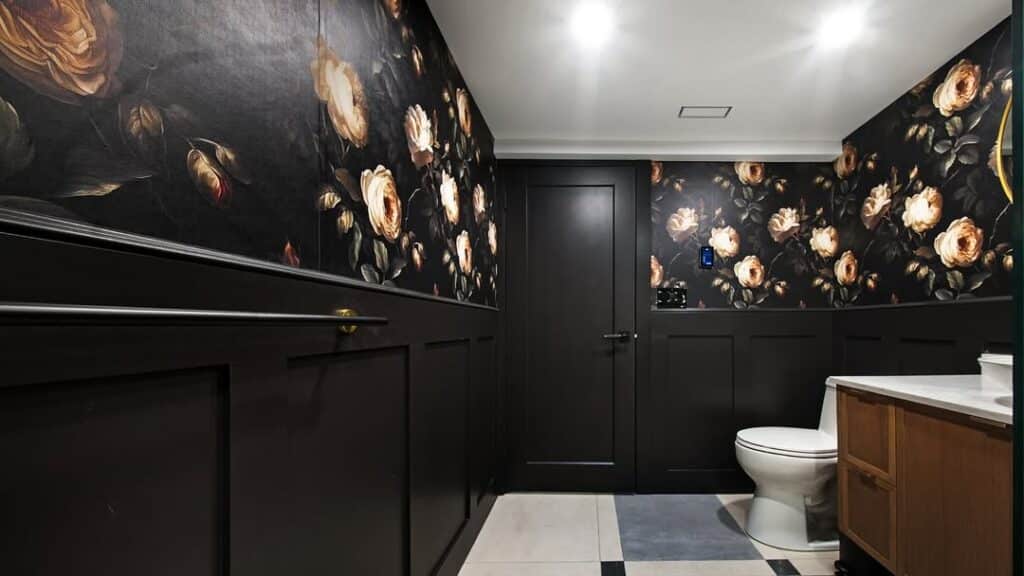 Powder room with moody floral walls in black