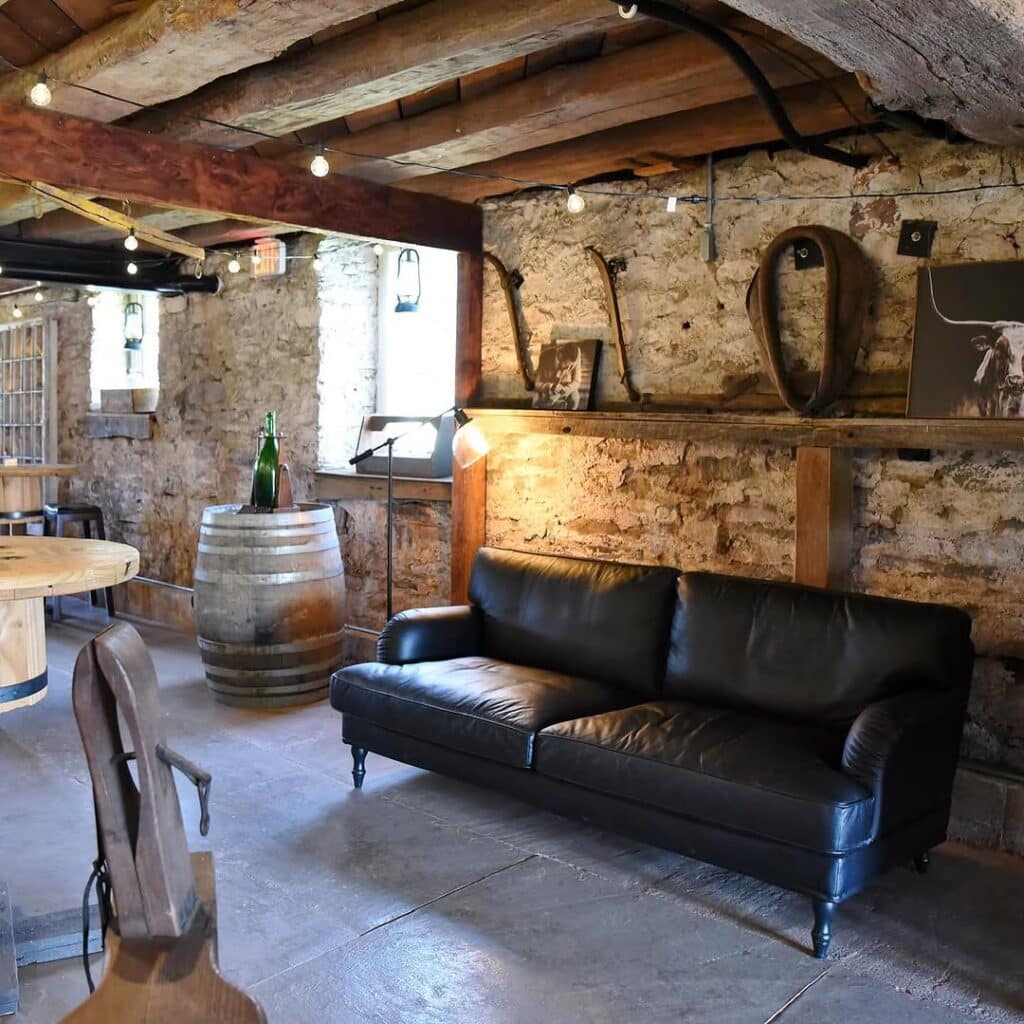 Primitive Tavern Gathering by a Stone Wall