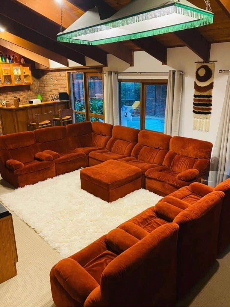 Rust Velvet Seating Area with a Fringed Light