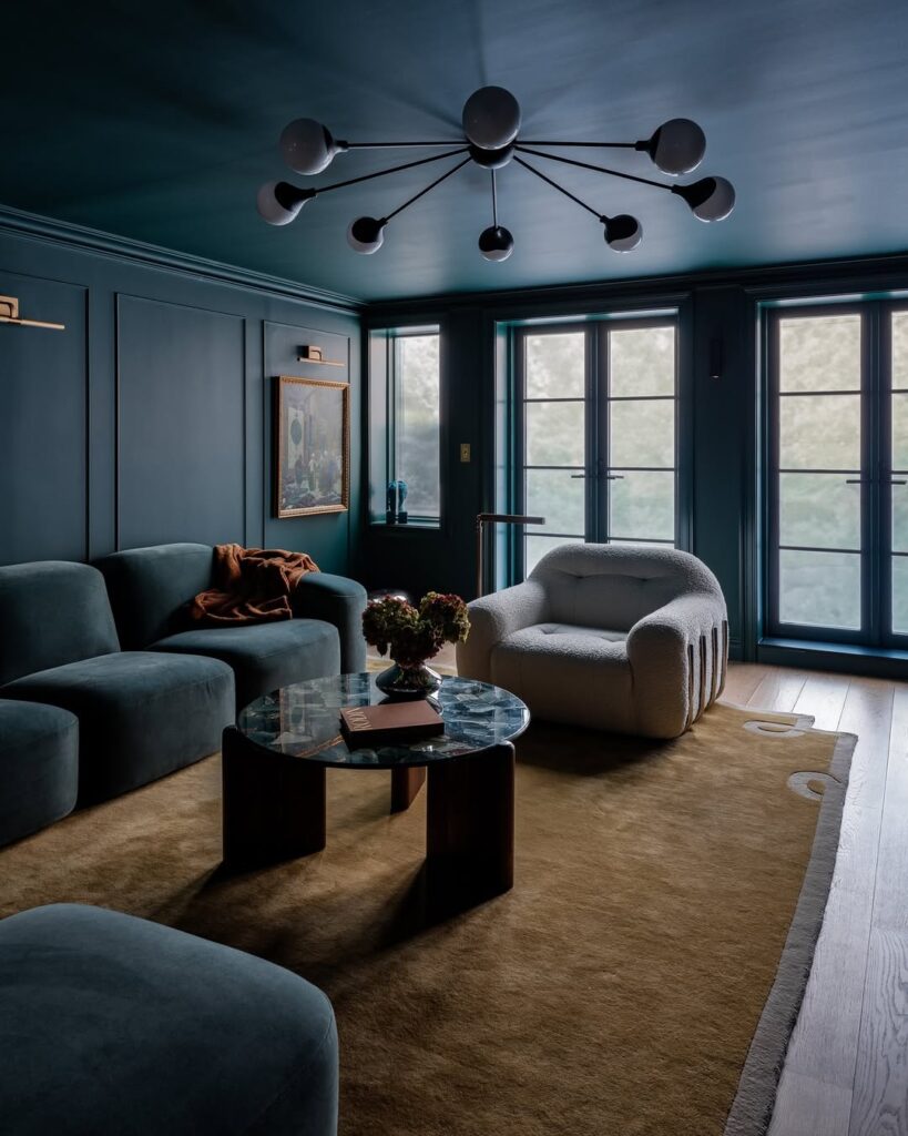 Sculptural light in a deep teal cocoon-like lounge