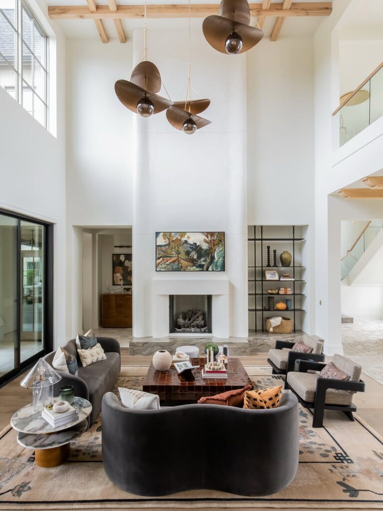 Sculptural Lighting by a Double-Height Fireplace