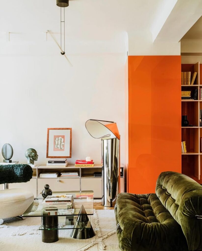 Tufted Olive Sofa and Glossy Orange Wall Panel