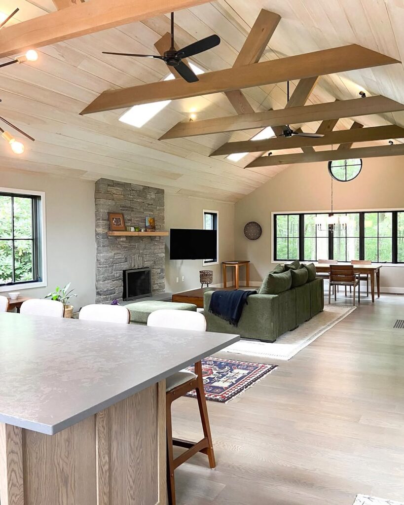 Vaulted Room with Skylight Exposed Beams and Stone Hearth