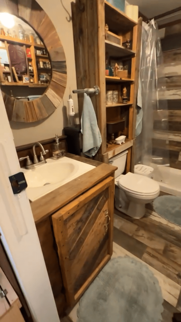 Vertical Reclaimed Wood Pantry Behind the Toilet