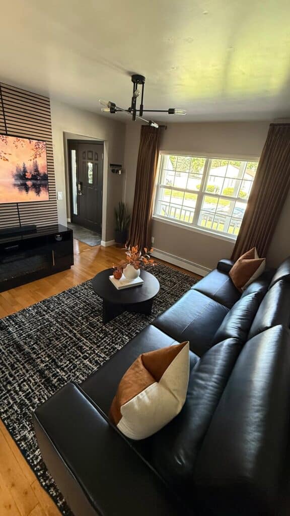 Warm Modern Room Anchored by a Black Sofa